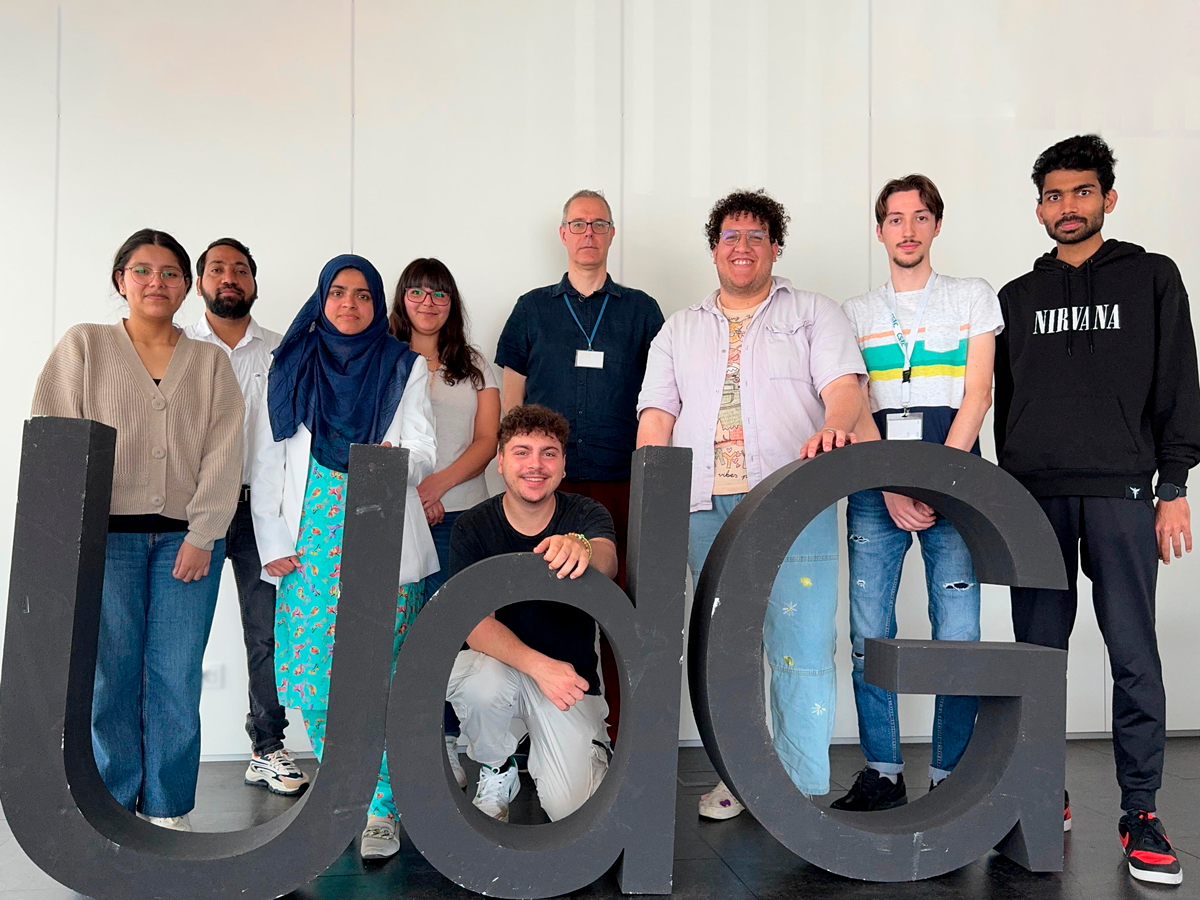 Nonheme iron-oxo oxidants team membes standing behind 3D sign that says UdG posing for camera