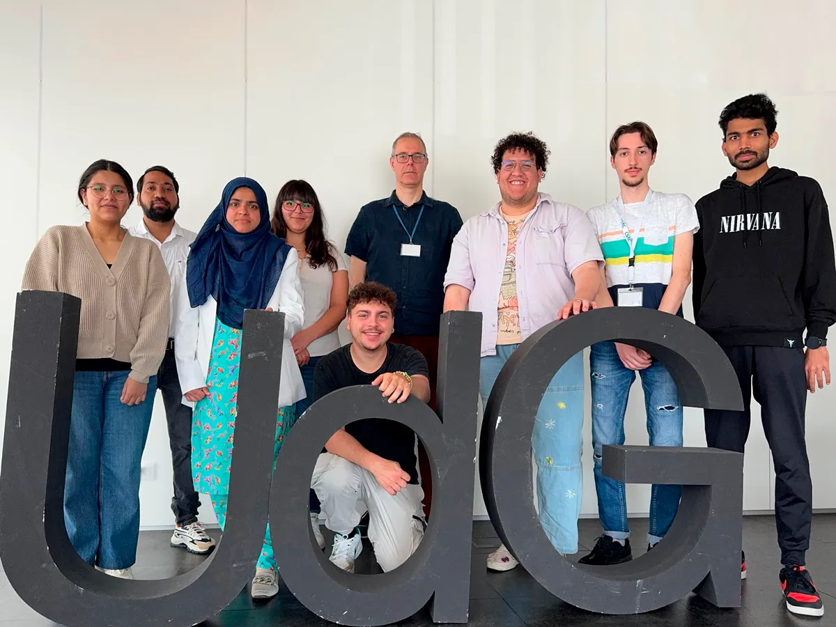 Nonheme iron-oxo oxidants team membes standing behind 3D sign that says UdG posing for camera