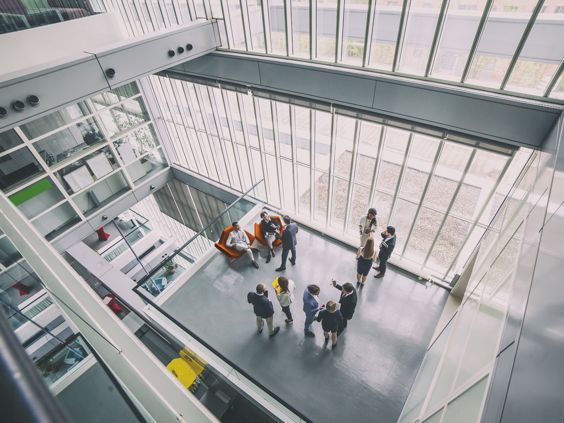 a group of people in a room with windows