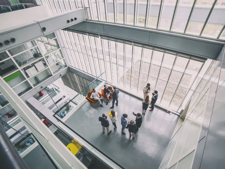 a group of people in a room with windows