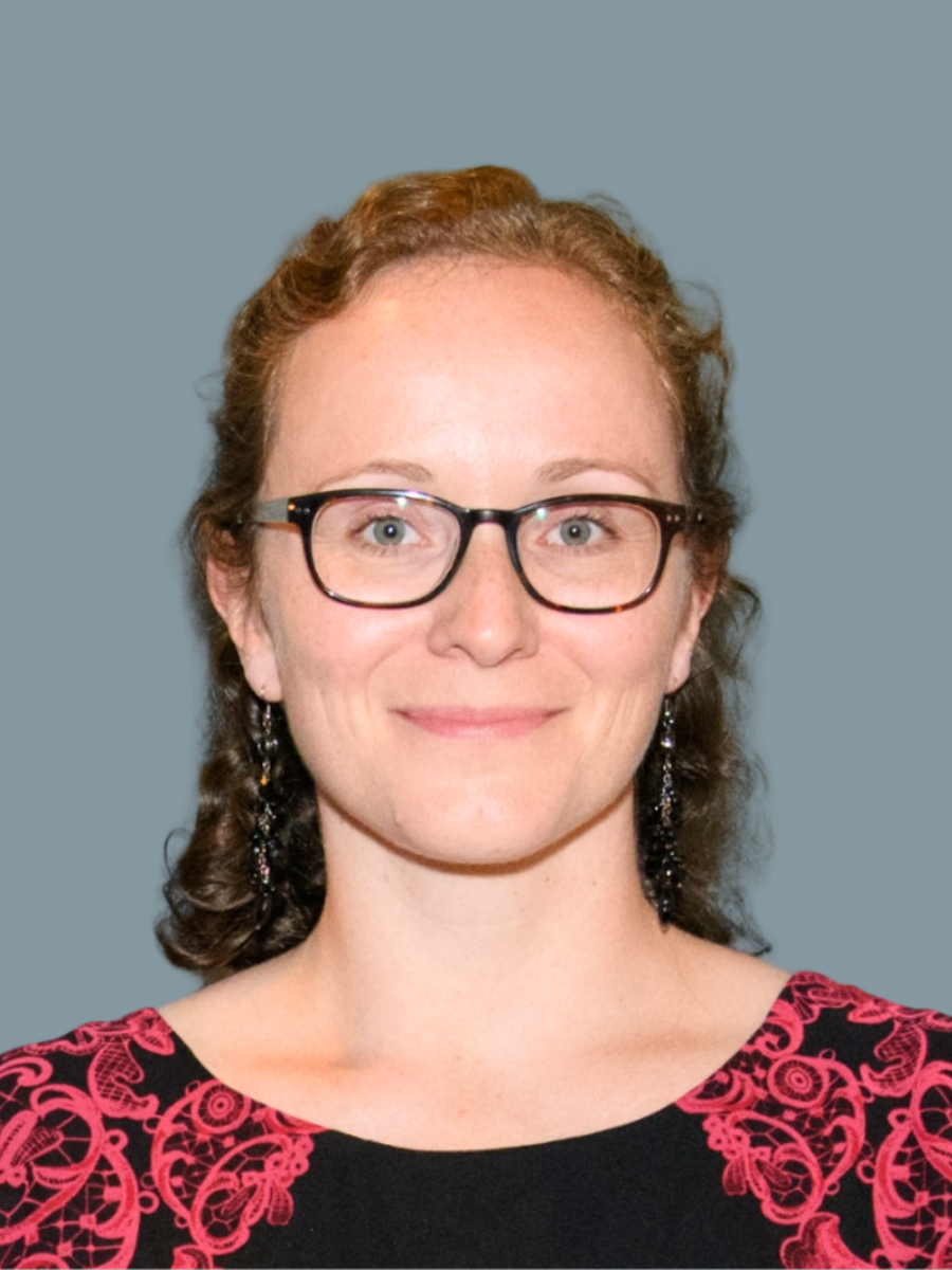 Professor Kim Jelfs wearing glasses and smiling at the camera