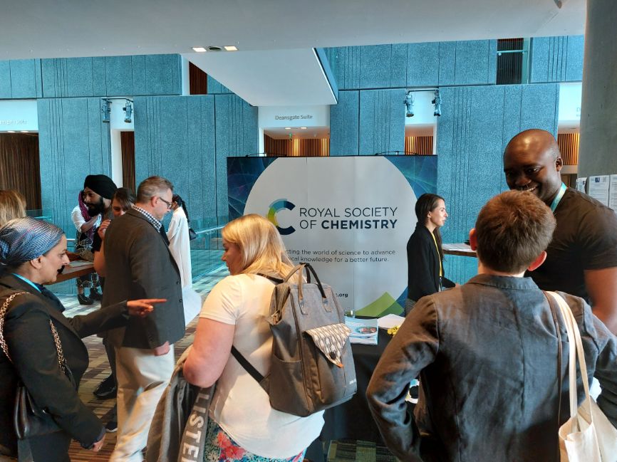 People mingling in front of a Royal Society of Chemistry hanging banner