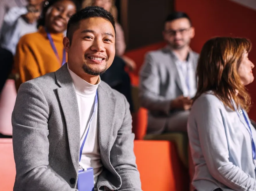 Asian male sitting in lecture hall seat