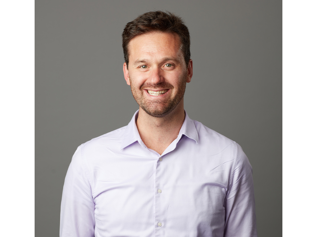 Professor Mauro Pasta in a white shirt smiling for camera