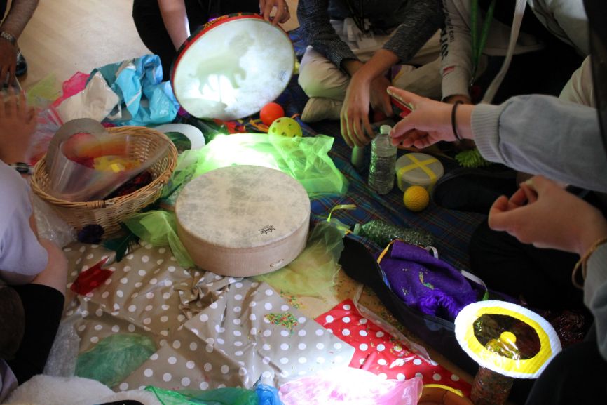 A finger points at a shadow art next to a table covered in materials A finger points at a shadow art next to a table covered in materials