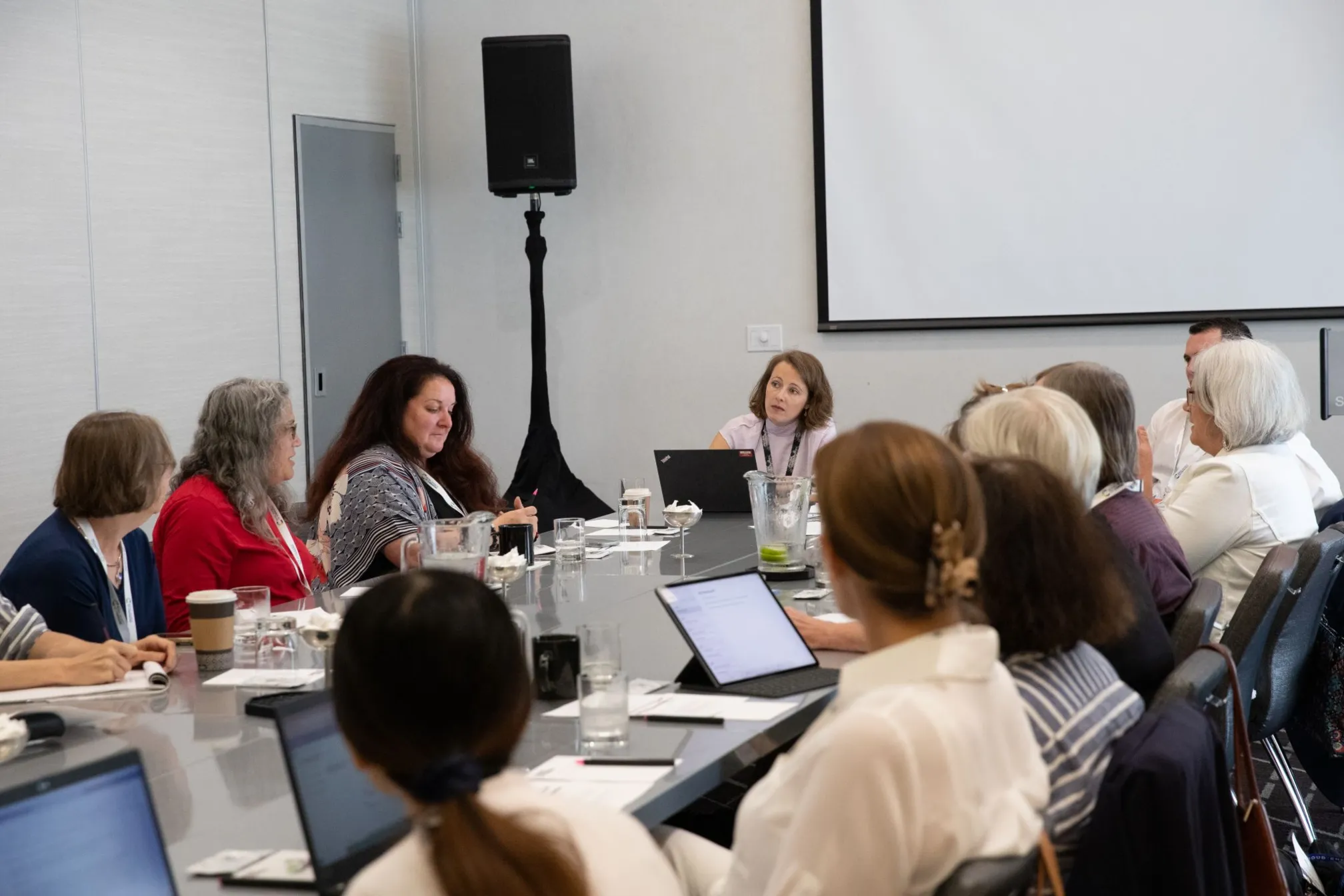 Sara Bosshart (centre) sits around a table listening to a speaker to the left of the picture during a conversation at an ACS event in San Francisco, USA