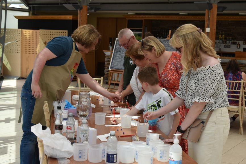 A family takes part in one of the activities at a table A family takes part in one of the activities at a table