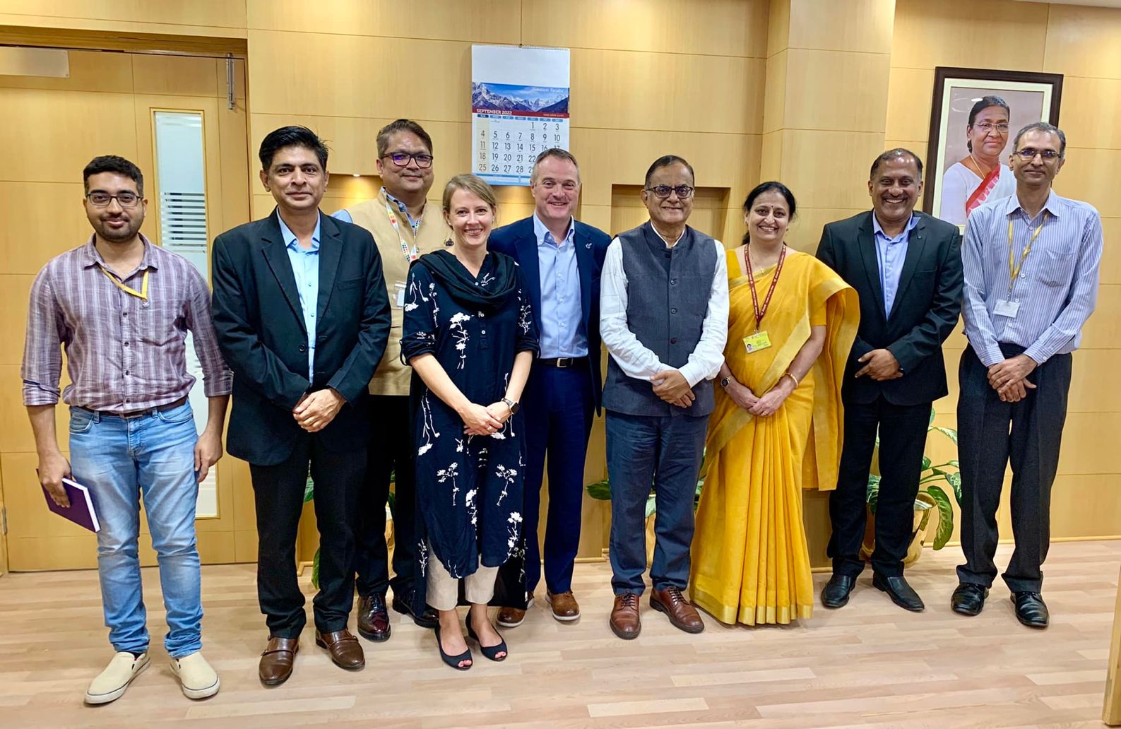 RSC representatives Sara Bosshart and Paul Lewis (fourth and fifth left) stand among a group of nine people at an event in Delhi, India