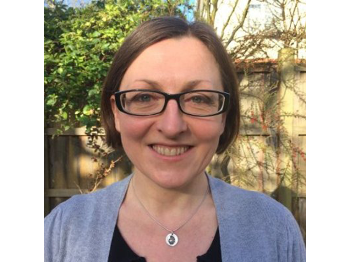 Dr Jennifer Kingston wearing glasses and smiling for the camera