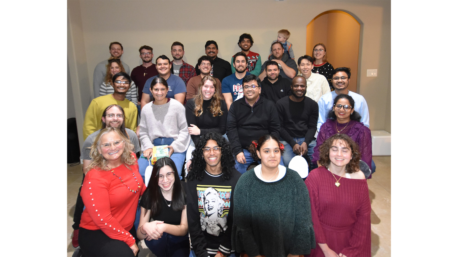 Professor Sarbajit Banerjee with a group of colleagues all posing for the camera in every day clothes