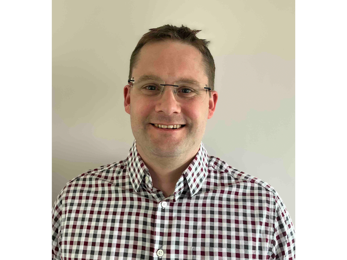 Professor Thomas Penfold wearing glasses and a checked shirt