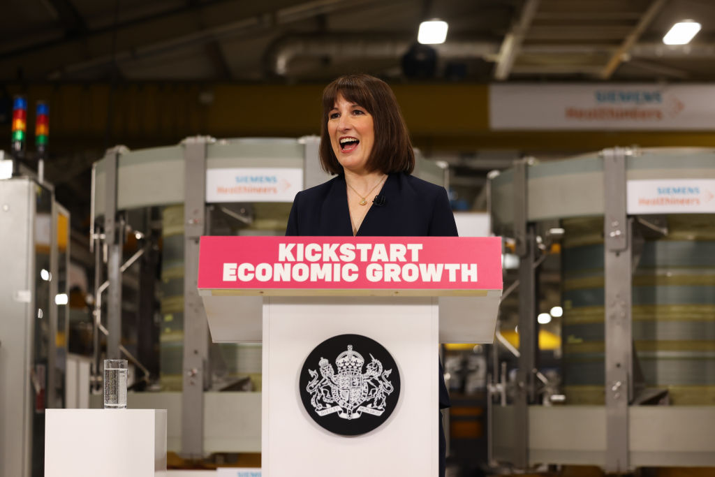 Chancellor of the Exchequer Rachel Reeves MP stands behind a lectern that reads "Kickstart economic growth" in a factory  Chancellor of the Exchequer Rachel Reeves MP stands behind a lectern that reads "Kickstart economic growth" in a factory