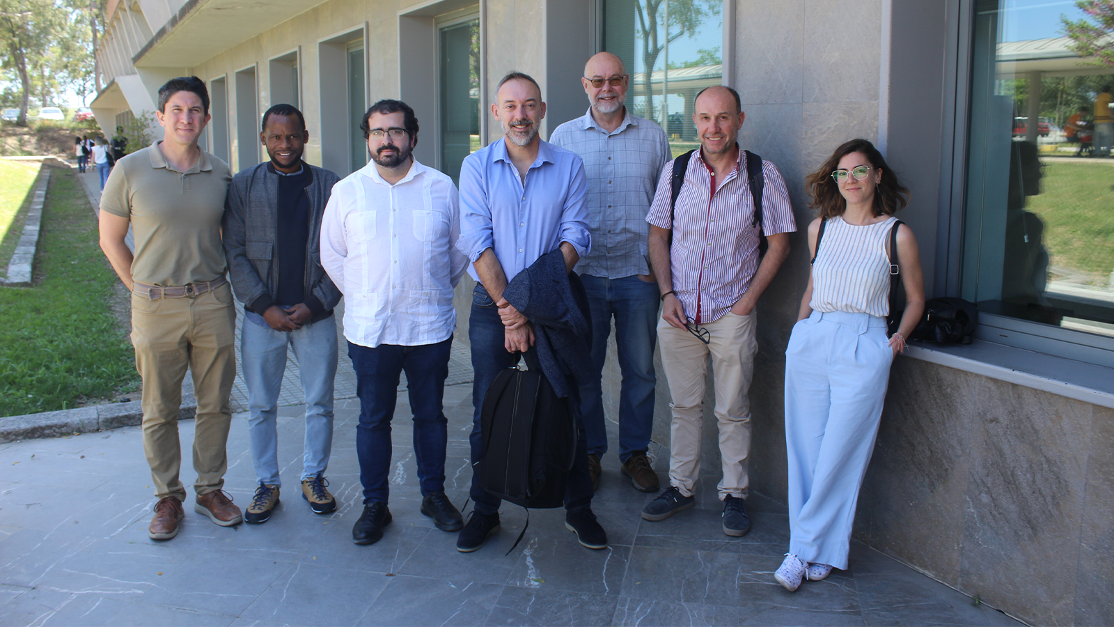 a group of people standing together outside a building