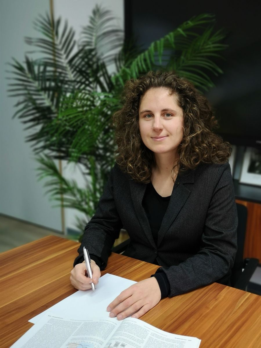 Professor Franziska Schoenebeck sitting at a desk writing