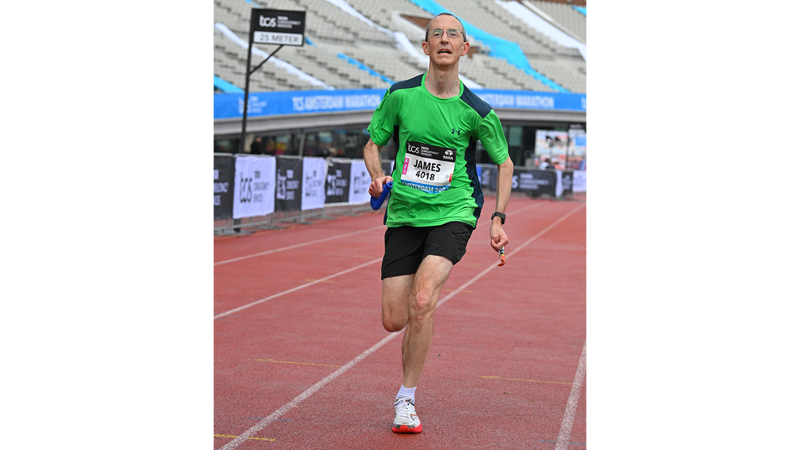 Dr James Redman running on a track in sportswear
