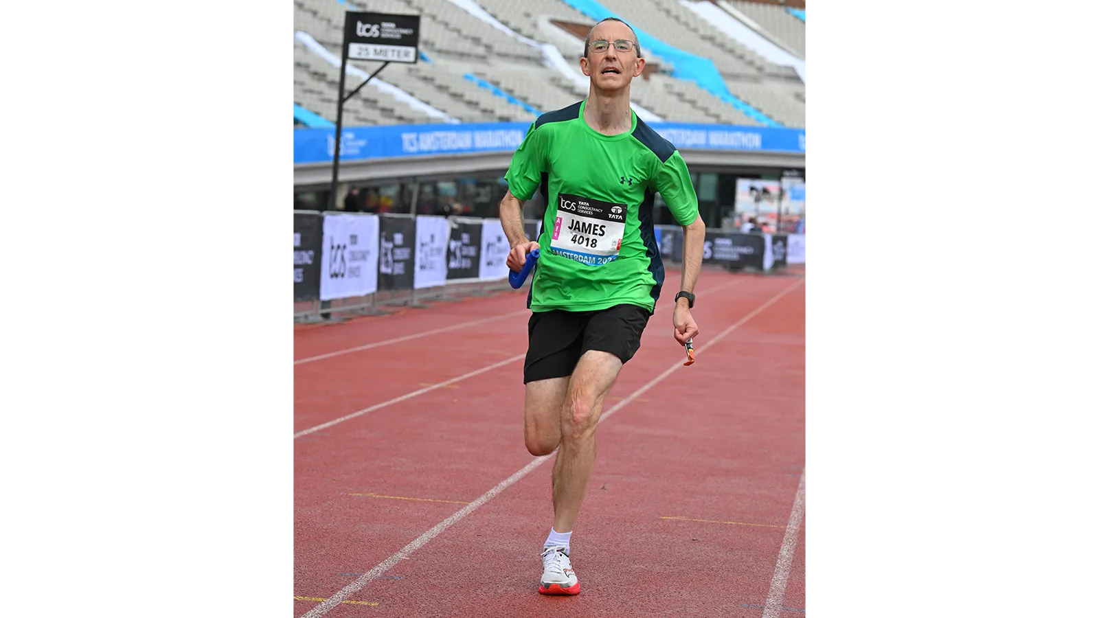 Dr James Redman running on a track in sportswear