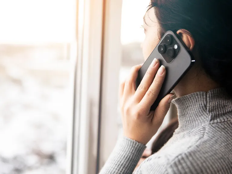 a woman holding a cell phone to her ear