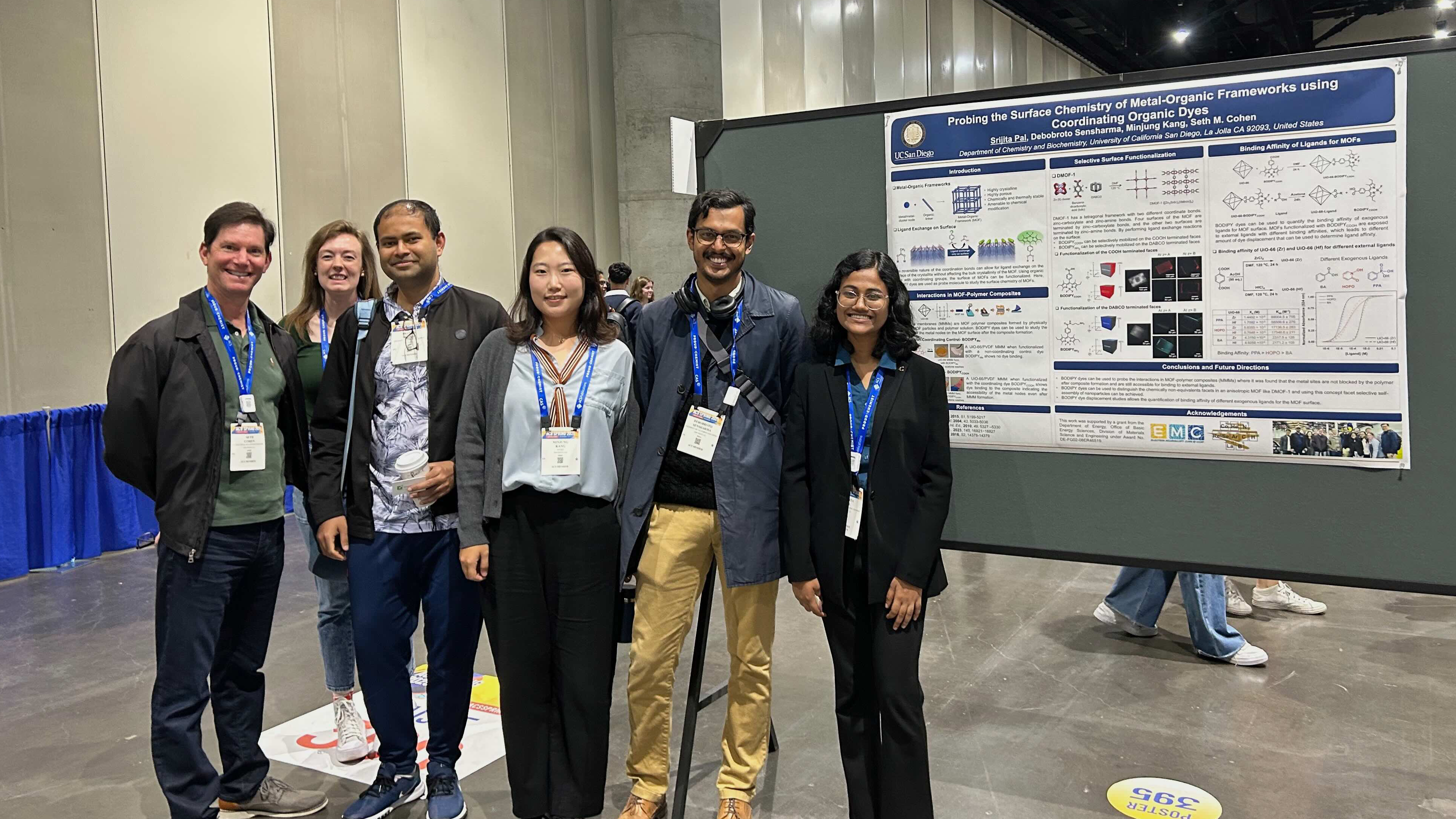 Professor Seth Cohen and others standing in front of a board at an event