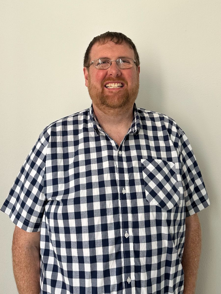 Professor Damion Corrigan in glasses and check shirt